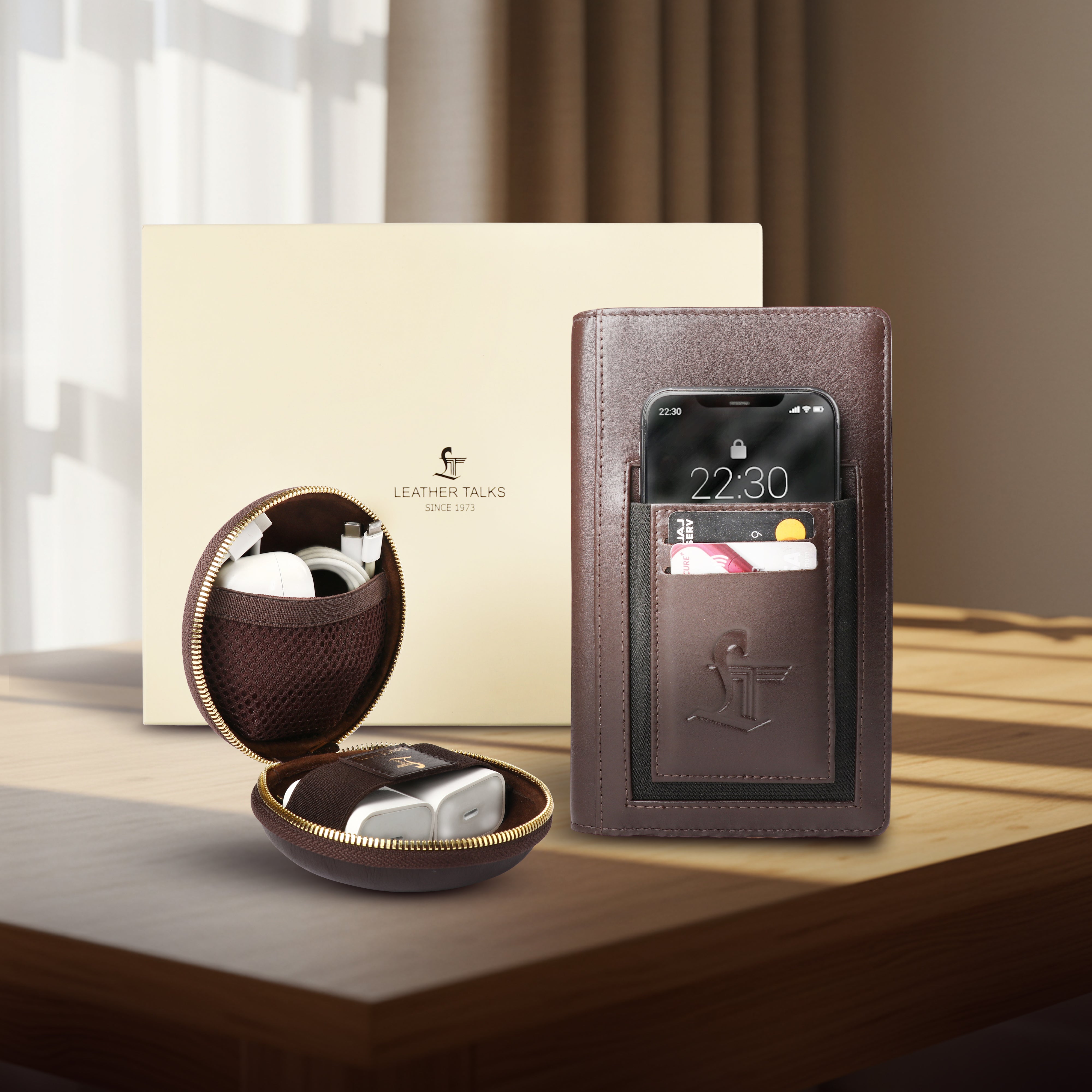 Leathertalks Brown leather phone case with screen protector and charging cable on a wooden surface.