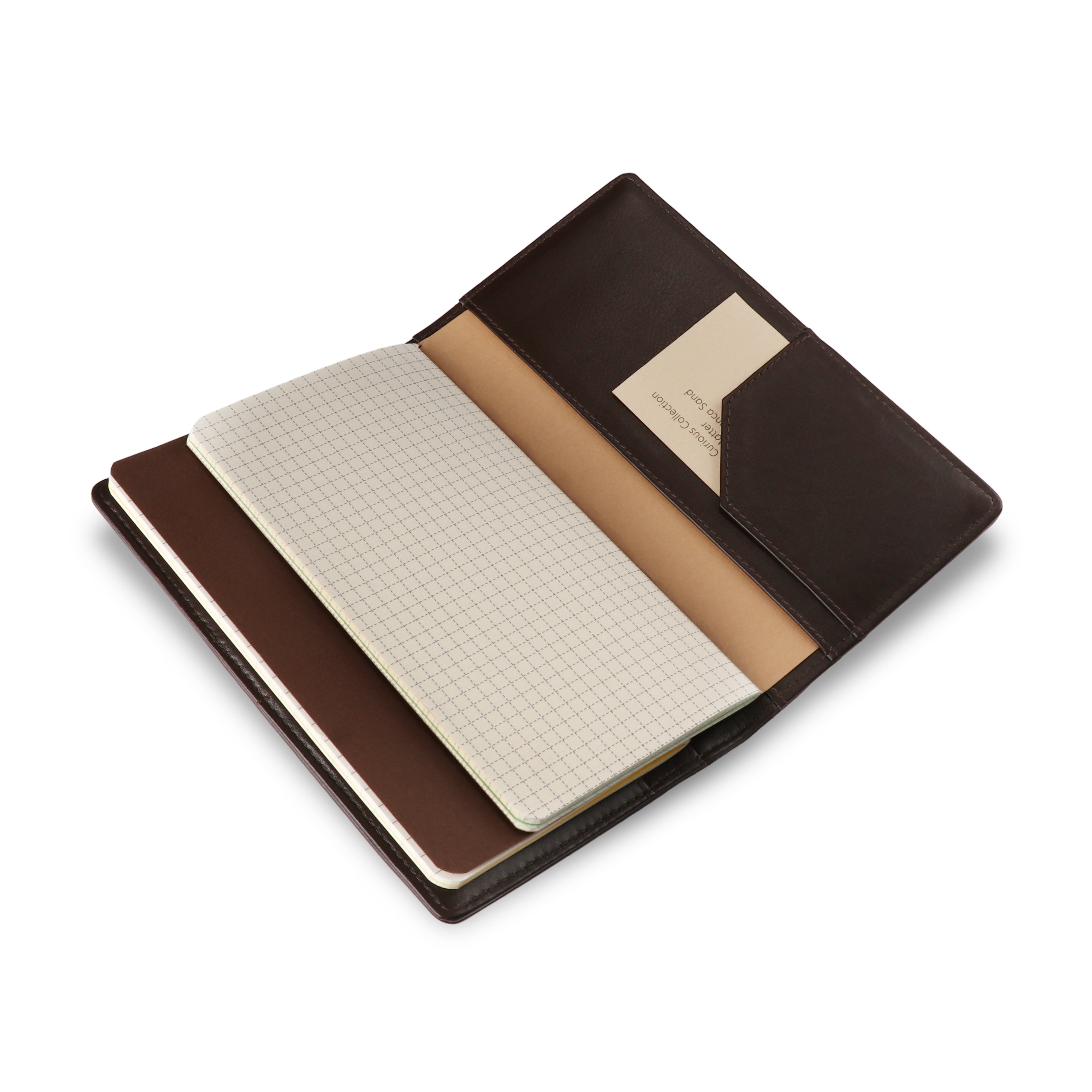 Open notebook with grid and plain pages in a brown leather cover on a white background