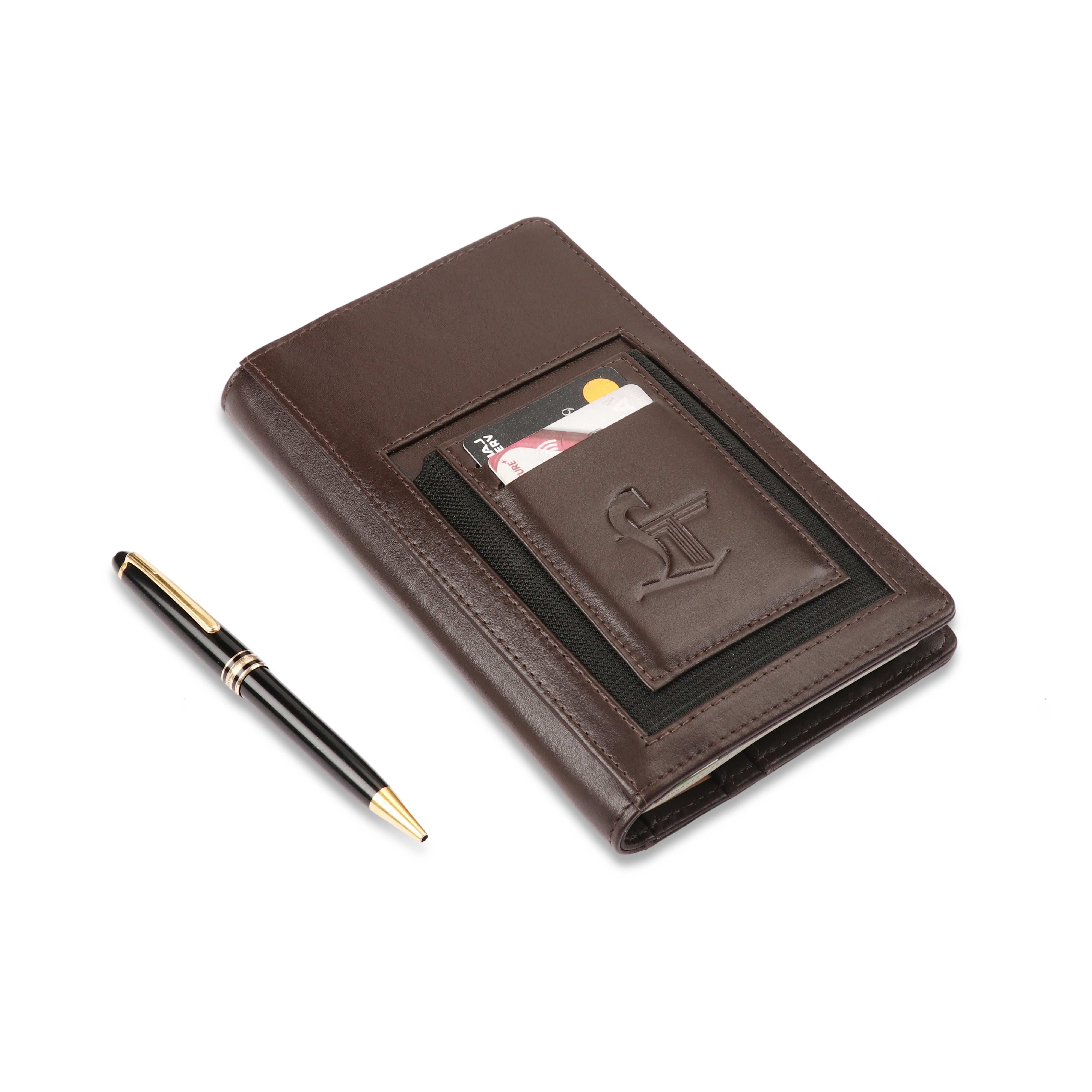 Brown leather notebook with card slots and a pen on a white background